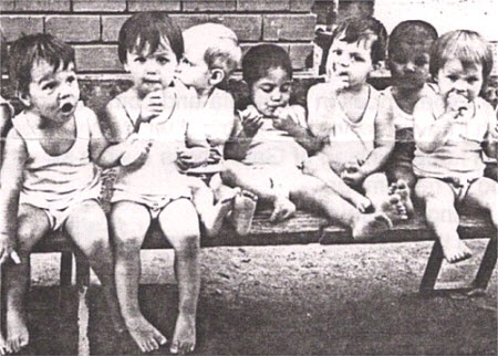 orphans sitting on a bench mothering